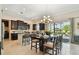 Kitchen with ample dark cabinets and a center island that opens to a dining area and sliding glass doors at 1140 Terralago Way, Kissimmee, FL 34746
