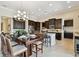 Gourmet kitchen featuring dark wood cabinets, a large island, and stainless steel appliances for modern living at 1140 Terralago Way, Kissimmee, FL 34746