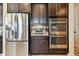 Modern kitchen features stainless steel appliances, dark wood cabinets, and granite countertops at 1140 Terralago Way, Kissimmee, FL 34746