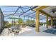 Comfortable, shaded lanai area with dining table and pool furniture at 1140 Terralago Way, Kissimmee, FL 34746