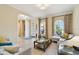Bright living room featuring tile floors, arched windows, and stylish furnishings at 1140 Terralago Way, Kissimmee, FL 34746