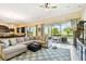 Bright and spacious living room with large windows overlooking a screened-in lanai with pool views at 1140 Terralago Way, Kissimmee, FL 34746