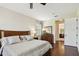 Spacious bedroom with hardwood floors, a large dresser and an attached ensuite at 1140 Terralago Way, Kissimmee, FL 34746