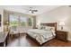Comfortable bedroom features hardwood floors, large windows, and neutral decor at 1140 Terralago Way, Kissimmee, FL 34746
