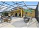 Expansive outdoor patio area with multiple seating options, a grill, and lush landscaping at 1140 Terralago Way, Kissimmee, FL 34746