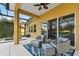 Covered patio with comfortable seating, ceiling fan, and view of the pool at 1140 Terralago Way, Kissimmee, FL 34746