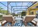 Relaxing pool area with in-pool lounge chairs under a screened enclosure at 1140 Terralago Way, Kissimmee, FL 34746