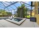 Screened-in pool area featuring a jacuzzi, in-pool lounge chairs, and ample space for relaxation at 1140 Terralago Way, Kissimmee, FL 34746