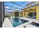 The screened in pool deck features in-pool loungers, spa, and patio seating at 1140 Terralago Way, Kissimmee, FL 34746