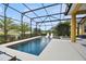 Backyard with a screened pool, spa, and lounge chairs under the enclosure at 1140 Terralago Way, Kissimmee, FL 34746