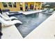 The backyard features a luxurious pool and spa with white loungers at 1140 Terralago Way, Kissimmee, FL 34746