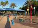 Community splash pad with colorful water features and shaded picnic area for Gathering fun at 1140 Terralago Way, Kissimmee, FL 34746