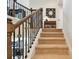Carpeted stairs with wood and decorative iron railing at 1140 Terralago Way, Kissimmee, FL 34746