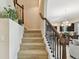 Carpeted staircase with decorative wrought iron and wood railing at 1140 Terralago Way, Kissimmee, FL 34746