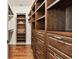 Custom walk-in closet with hardwood floors, built-in shelving, and ample storage space at 1140 Terralago Way, Kissimmee, FL 34746