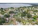 Aerial view showcasing a residential neighborhood near a large lake and lush green trees at 1212 Blake Ave, Auburndale, FL 33823
