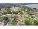 Aerial view highlighting a residential area with houses, pools, and a small lake at 1212 Blake Ave, Auburndale, FL 33823