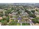 Neighborhood aerial view with mature trees, showcasing community, and a home with cozy curb appeal at 1212 Blake Ave, Auburndale, FL 33823