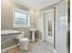 Bathroom with pedestal sink, toilet, tiled floor, and walk-in shower at 1212 Blake Ave, Auburndale, FL 33823