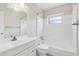 Bright, all-white bathroom with shower-tub combo and updated vanity at 1212 Blake Ave, Auburndale, FL 33823