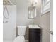 Compact bathroom featuring a black vanity and shower with wall mounted shower head at 1212 Blake Ave, Auburndale, FL 33823
