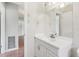 This is a bright bathroom with a white vanity and framed mirror at 1212 Blake Ave, Auburndale, FL 33823