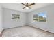 Bedroom featuring tiled floors, a ceiling fan, and natural light at 1212 Blake Ave, Auburndale, FL 33823