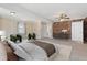Bedroom featuring an exposed brick wall, ceiling fan, and neutral carpeting at 1212 Blake Ave, Auburndale, FL 33823