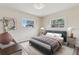 Cozy bedroom with natural light from two windows and neutral decor at 1212 Blake Ave, Auburndale, FL 33823