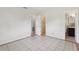Spacious bedroom featuring an open closet, tile floor, and a full bathroom at 1212 Blake Ave, Auburndale, FL 33823