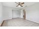 Bedroom with tile floors, ceiling fan, and closet for storage at 1212 Blake Ave, Auburndale, FL 33823