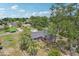 Aerial view of a brick home, showcasing the landscape and the surrounding neighborhood at 1212 Blake Ave, Auburndale, FL 33823