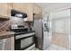 Well-equipped kitchen featuring stainless steel appliances and tiled backsplash at 1212 Blake Ave, Auburndale, FL 33823