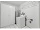 Functional laundry area with washer, dryer, water heater and storage at 1212 Blake Ave, Auburndale, FL 33823