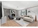 Bright living room features a brick fireplace, tile floors, and a comfortable sectional sofa at 1212 Blake Ave, Auburndale, FL 33823