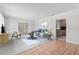Bright living room with neutral tones, and views of the bonus room and kitchen at 1212 Blake Ave, Auburndale, FL 33823
