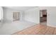 Open living space featuring plush carpeting and tile flooring, bonus room and access to kitchen at 1212 Blake Ave, Auburndale, FL 33823