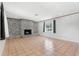 Living room features a brick fireplace, tile floors, and natural light at 1212 Blake Ave, Auburndale, FL 33823