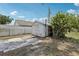 Backyard shed on a sunny day with a paved section in the back at 1212 Blake Ave, Auburndale, FL 33823