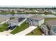 Aerial view of the home surrounded by houses, highlighting a pond and long driveway at 1424 Axel Cir, Winter Haven, FL 33880