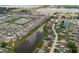 Aerial view of the community with many homes surrounding a long pond at 1424 Axel Cir, Winter Haven, FL 33880