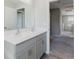 Bathroom with dual sink vanity and modern fixtures with an open view to the hallway at 1424 Axel Cir, Winter Haven, FL 33880