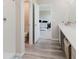 Bathroom with tub/shower, vanity, walk-in closet access and view into bedroom at 1424 Axel Cir, Winter Haven, FL 33880