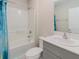 Clean bathroom featuring a white bathtub and shower combination, complemented by a gray vanity at 1424 Axel Cir, Winter Haven, FL 33880