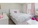 Cozy bedroom features bright pink decor with a bed, books, and table at 1424 Axel Cir, Winter Haven, FL 33880