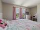 Charming bedroom with pink decor, natural light, and a view to the neighborhood at 1424 Axel Cir, Winter Haven, FL 33880