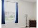 Bright bedroom with window views, and a nightstand with a storage basket at 1424 Axel Cir, Winter Haven, FL 33880