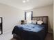 Comfortable bedroom with a cozy blue comforter and a window that brings in sunlight at 1424 Axel Cir, Winter Haven, FL 33880