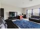 Spacious living room with a view of a large window, sofa, and office setup at 1424 Axel Cir, Winter Haven, FL 33880