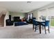 Spacious living area with multiple sofas, a dining set, and large windows providing natural light at 1424 Axel Cir, Winter Haven, FL 33880